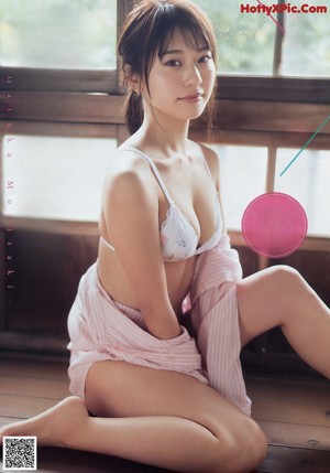A woman in a red bikini posing for a magazine.