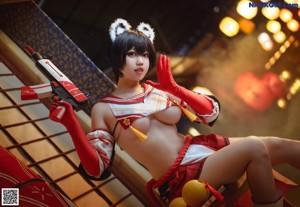 A woman in a red and white outfit holding a sword.