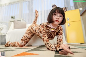 A woman in a leopard print outfit sitting on a set of stairs.
