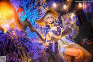 A woman dressed as a witch holding a pumpkin and a feather.
