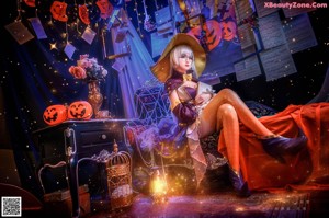 A woman dressed as a witch holding a pumpkin and a feather.
