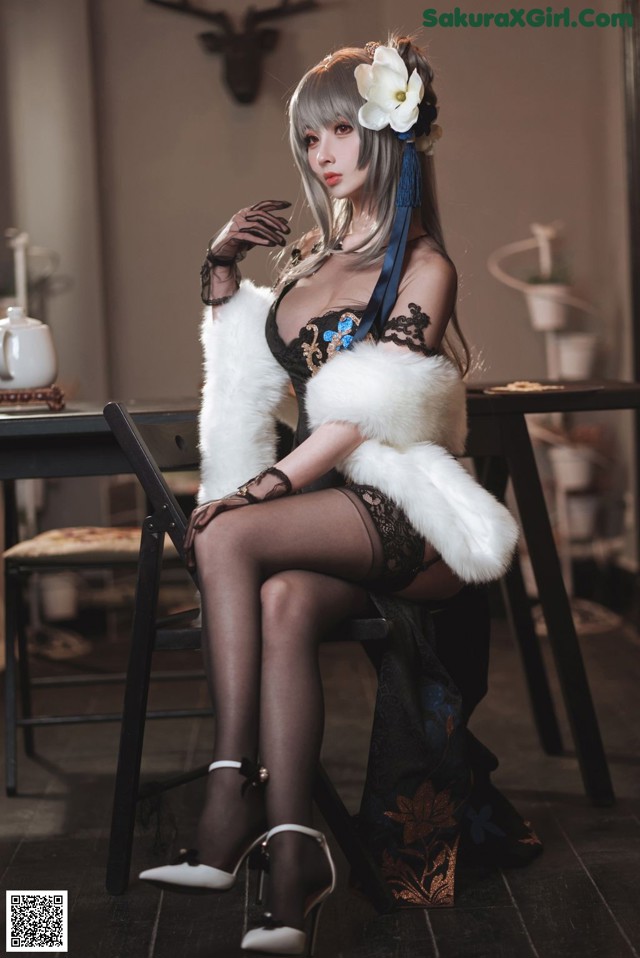A woman sitting on a chair in a room.