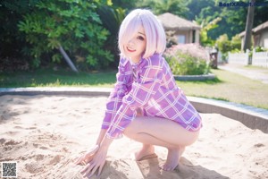 A woman in a purple and white outfit standing on a dock.