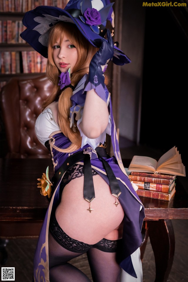 A woman in a witch costume posing for a picture.