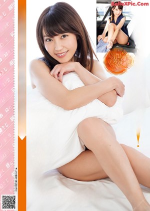 A woman in a white lingerie sitting on a brown couch.