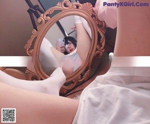 A woman taking a selfie in a mirror.