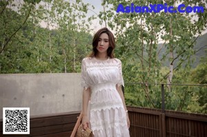 a woman in a pink dress standing on some steps