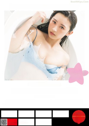 A woman in a blue lingerie sitting in a bathtub.