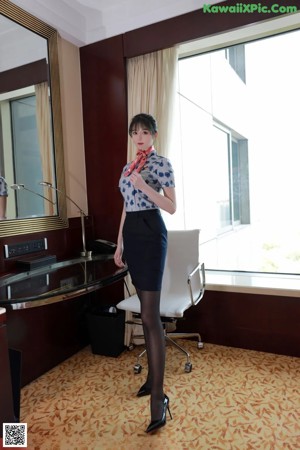 A woman sitting on a chair in a room.