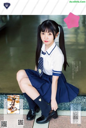 A young woman wearing a school uniform and a tie.