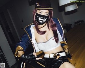 A woman wearing a mask and gloves leaning against a window.