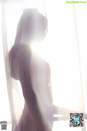 A woman in a white top and purple pantyhose.