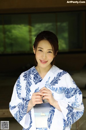 A naked woman laying on a tatami mat on the floor.