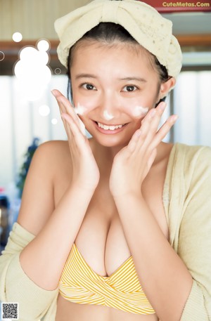 A woman in a blue bikini posing for a magazine cover.