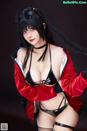 A woman in a black and silver outfit posing for a picture.
